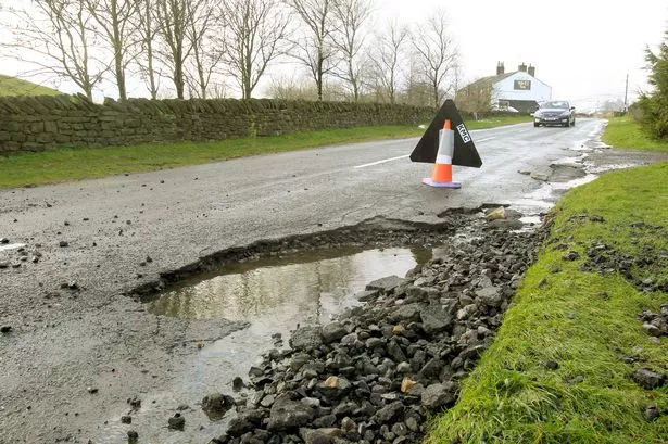 A giant pot hole in Linthwaite is wrecking cars